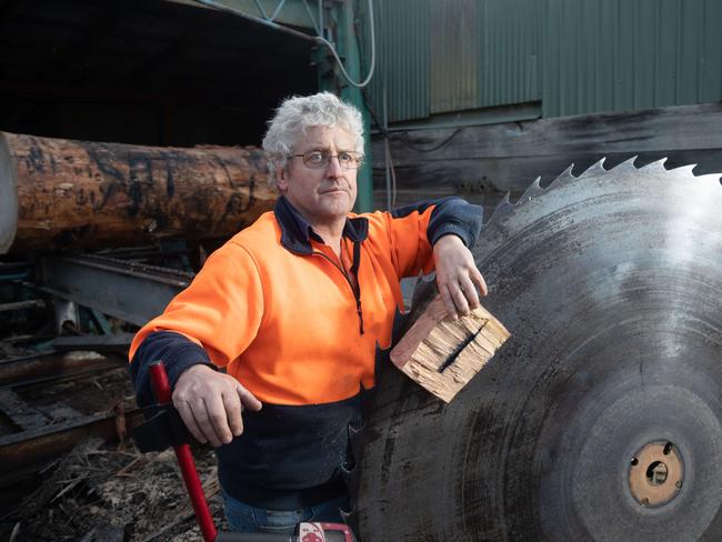 Wayne Booth of Karanja Timbers at Karanja in the upper Derwent Valley in southern Tasmania where sawmillers have  found metal spikes embedded in logs over the last couple of days.Photographed with a damaged saw blade and a block cut out of one of the logs to remove the spikes and his grandsons metal detector that they have been using to find the spikes.20/05/2020photo by Peter Mathew
