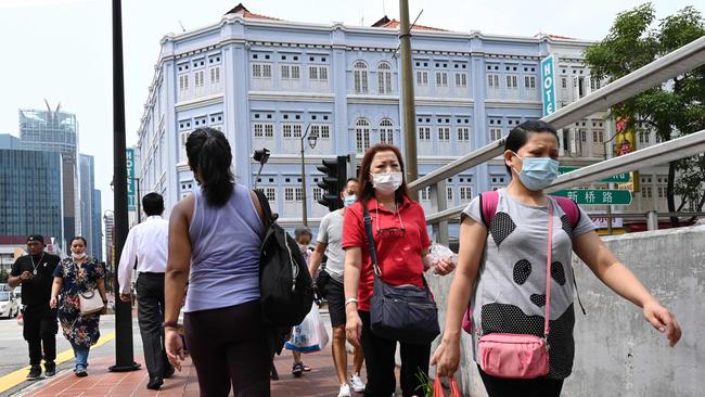 People walk along the footpath in Chinatown district in Singapore. Picture: AFP