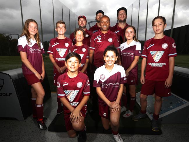 The diminutive Brazilian with Coomera coaches and junior players. Picture: Jason O'Brien