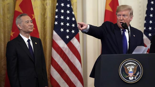 President Donald Trump speaks before signing a trade agreement with Chinese Vice Premier Liu He, left, at the White House.