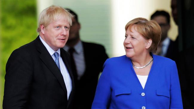 BERLIN, GERMANY - AUGUST 21: British Prime Minister Boris Johnson (L) and German Chancellor Angela Merkel (R) chat before reviewing a guard of honor upon Johnson's arrival at the Chancellery on August 21, 2019 in Berlin, Germany. Johnson is meeting with Merkel in Berlin and French President Emmanuel Macron in Paris. The United Kingdom has an October 31 deadline to leave the European Union with or without a departure deal with the EU. (Photo by Carsten Koall/Getty Images)