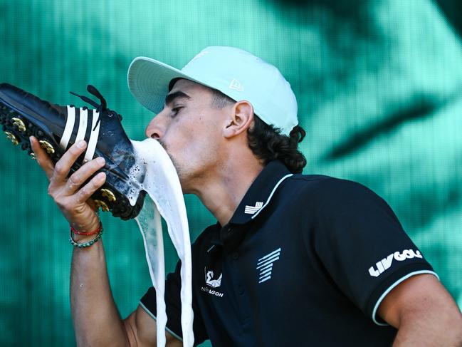 ADELAIDE, AUSTRALIA - FEBRUARY 16: Joaquin Niemann of Torque celebrates with a shoey on stage after winning the  LIV Golf Adelaide at The Grange Golf Club on February 16, 2025 in Adelaide, Australia. (Photo by Mark Brake/Getty Images)