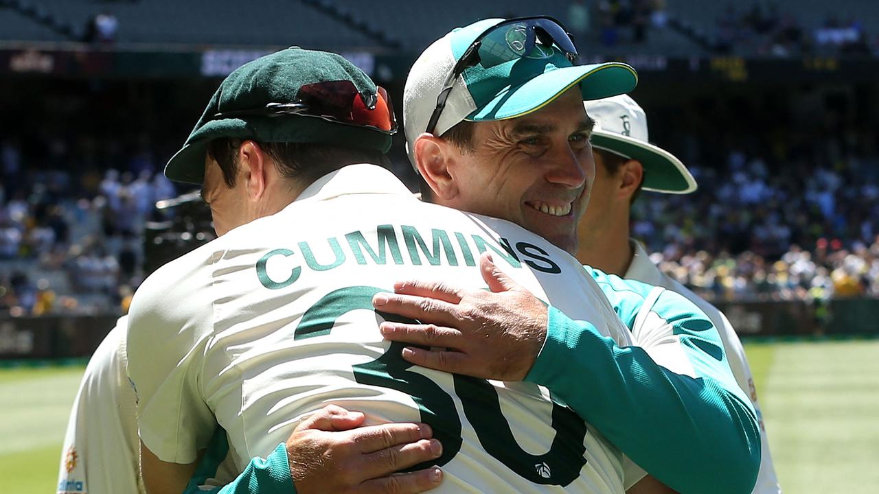 Australia's captain Pat Cummins gives a hug to coach Justin Langer on Tuesday.