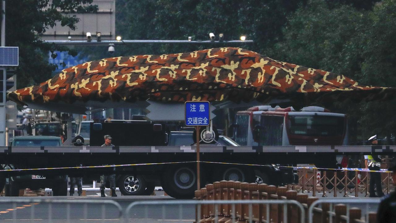 A Chinese military vehicle possibly carrying a drone passes along the Jianguomenwai Avenue in Beijing on Saturday. Picture: Andy Wong/AP