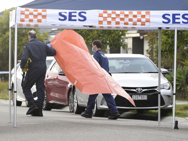 Police investigate the area around Observatory St at Clyde North on Friday. Picture: Andrew Henshaw