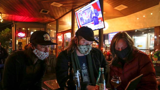 Seattle residents monitor election results on a laptop during an election night event at The Growler Guys in Seattle. Picture: AFP.