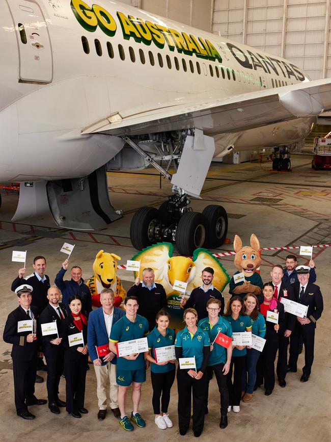 Members of Australia’s Olympic and Paralympics team with a Qantas 787 emblazoned with Go Australia. Picture: Qantas