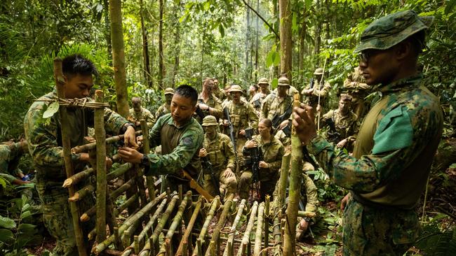 Royal Brunei Land Force officers and soldiers show Australian Army soldiers from Rifle Company Butterworth Rotation 137 how to catch food in the Bruneian rainforests during Exercise Mallee Bull. Picture: Guy Sadler.