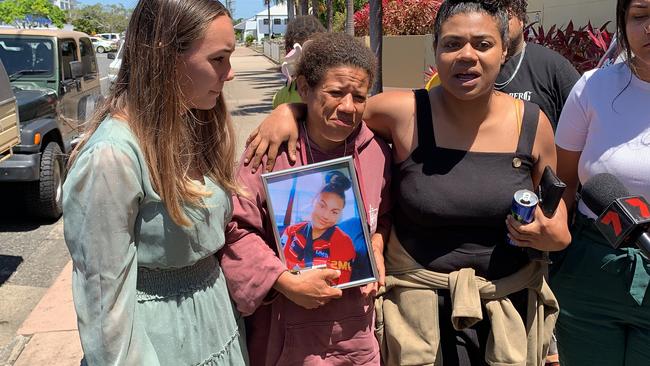 Nilly's mother Tania Rudall holds a photo of her 15 year old daughter as she leaves court surround by loved ones who came to watch the court case for the driver linked to Nilly's death.