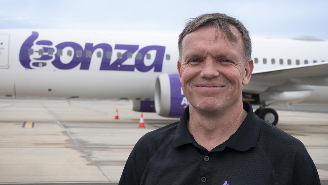 Bonza CEO Tim Jordan stands in front of the low-cost airline's first plane at Sunshine Coast Airport.