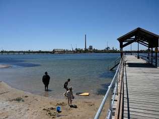 Children play on a beach near the lead smelter in Port Pirie. Picture: NCA NewsWire / David Mariuz