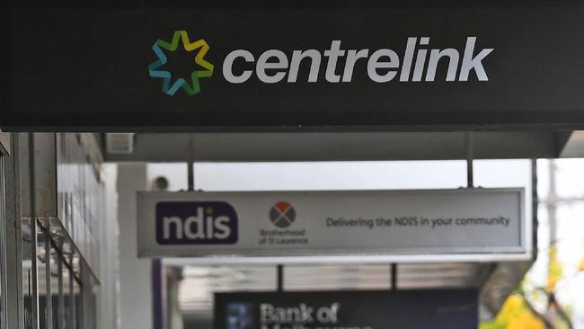 People queue up outside a Centrelink office in Melbourne on April 20, 2020, which delivers a range of government payments and services for retirees, the unemployed, families, carers and parents amongst others. - A report from the Grattan Institute predicts between 14 and 26 per cent of Australian workers could be out of work as a direct result of the coronavirus shutdown, and the crisis will have an enduring impact on jobs and the economy for years to come. (Photo by William WEST / AFP)