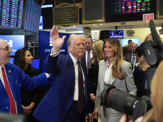 President-elect Donald Trump, with Lynn Martin, President NYSE, centre, Melania Trump, right and trader Peter Giacchi, left, walks the floor of the New York Stock Exchange. Picture: AP