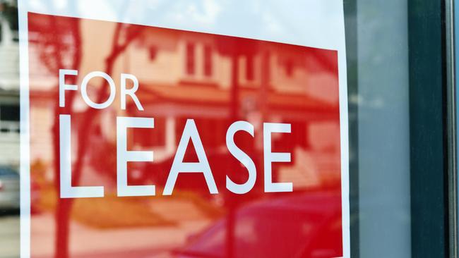 For Lease sign on red in window reflecting street scene.Source: iStock