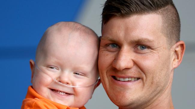 Queensland Children's Hospital intensive care nurse Dakota Parker has been nominated for a Pride of Australia award for the care he gave Ethan Moodie when the baby was there in December last year.  Dakota with Ethan now, and Ethan's Mum Tara Moodie. Pic Bruce Long