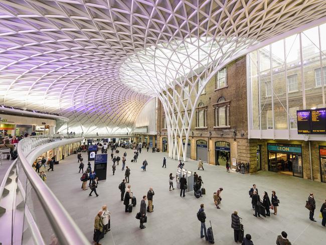 London, UK - May 2, 2012: People in the departure concourse of King's Cross Station.  The station serves as an important national railway terminus, and as part of the London Underground network.  The redesigned concourse was opened in March 2012.