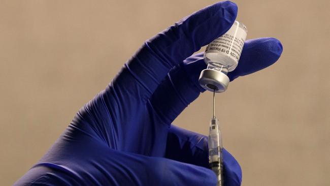 A pharmacist fills a syringe to prepare a dose of the Pfizer-BioNTech Covid-19 vaccine for frontline health care workers at a vaccination site at Torrance Memorial Medical Center in Torrance, California. Picture: AFP