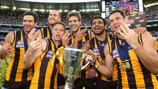 Lewis and Roughead celebrate their third premiership with teammates in 2014. Picture: Getty