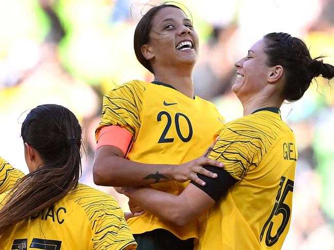 Australia's Sam Kerr (centre) celebrates with teammate Emily Gielnik (right) after scoring against Argentina.