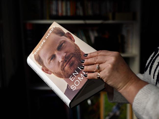 A woman leafs through the Spanish version of Prince Harry's autobiography after buying it in Madrid. Picture: AFP