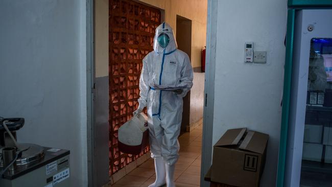 A technician carries samples from truck drivers testing for COVID-19 coronavirus at the laboratory of Kenya Medical Research Institute.