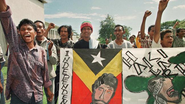 Students protest behind a banner depicting jailed East Timorese rebel leader Xanana Gusmao during a rally at the University of East Timor, Dili, in 1998. Picture: AP