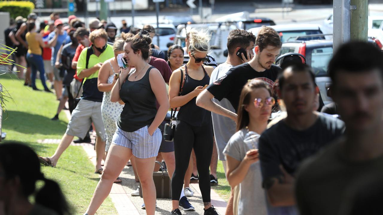 Lines of people wait at Southport Centrelink. Picture: Adam Head.