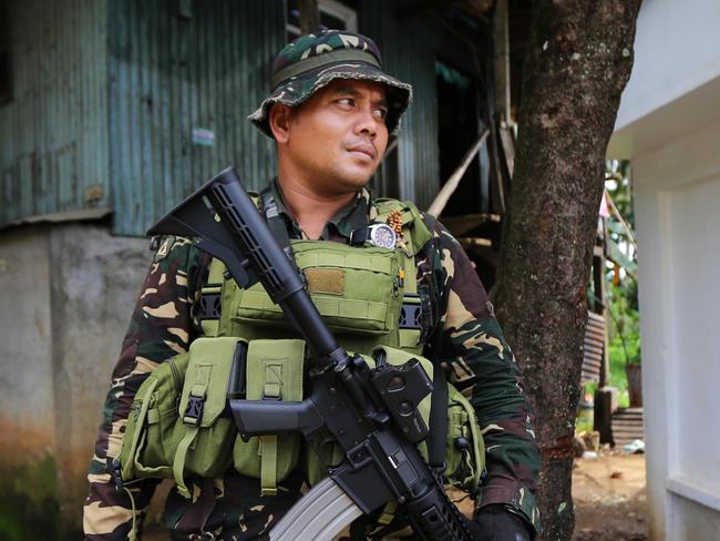 Soldiers stop and inspect all vehicles and check peoples ID's at military checkpoints leading into Marawi. Picture: Gary Ramage