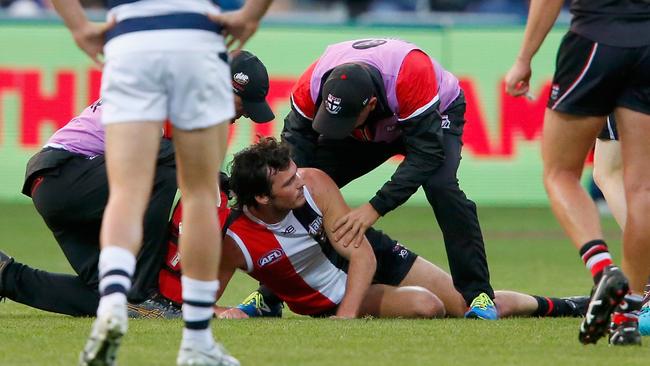 Trainers assist Dylan Roberton after he collapsed behind play.