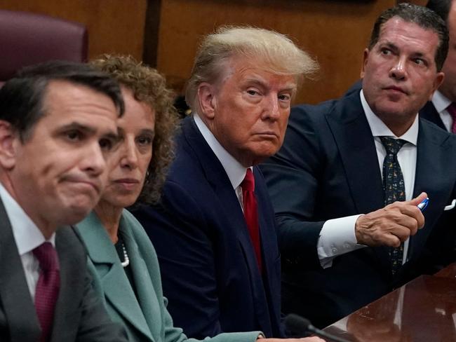 Former US president Donald Trump (C) appears in court at the Manhattan Criminal Court in New York on April 4, 2023. - Former US president Donald Trump arrived for a historic court appearance in New York on Tuesday, facing criminal charges that threaten to upend the 2024 White House race. (Photo by Timothy A. CLARY / POOL / AFP)