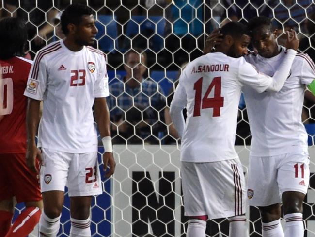 Abdulaziz Sanqour (C) of UAE congratulates teammate Ahmed Khalil after his goal during the third-place play-off football match between Iraq and United Arab Emirates at the AFC Asian Cup in Newcastle on January 30, 2015. AFP PHOTO / Saeed Khan --IMAGE RESTRICTED TO EDITORIAL USE - STRICTLY NO COMMERCIAL USE