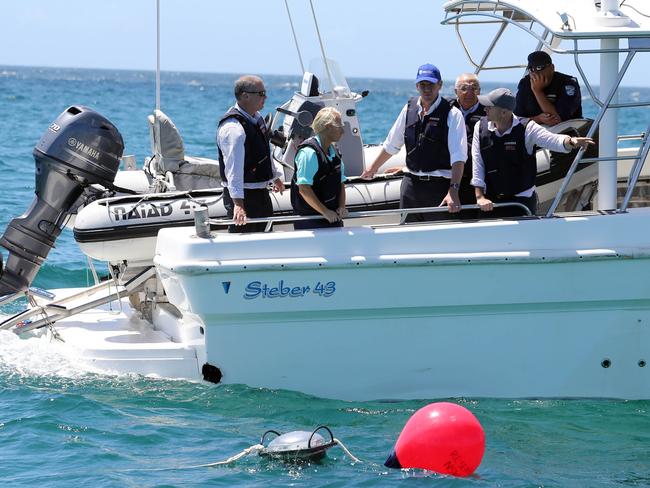 Premier Mike Baird inspects a drumline off the coast of Ballina last December / Picture: Jason O'Brien