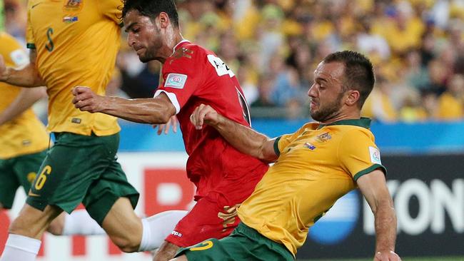 Australia's Ivan Franjic, right, takes the ball from Oman's Abdul Aziz Al-Maqbali.