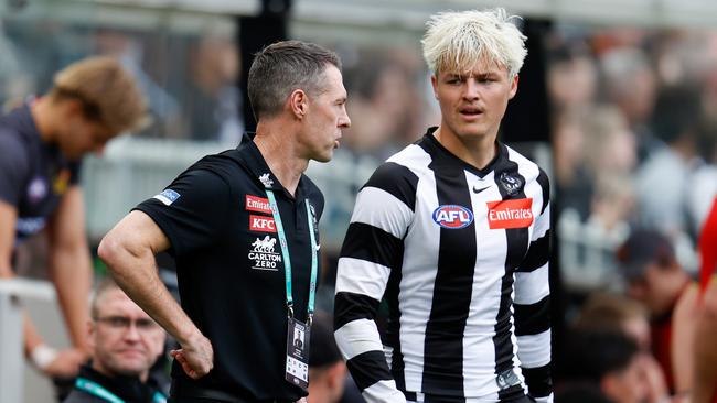 Craig McRae speaks with young Magpies forward Jack Ginnivan.