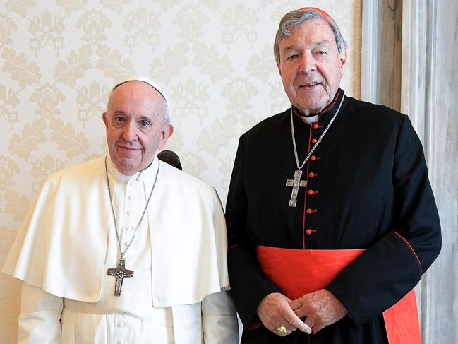 This handout photo taken on October 12, 2020, and released by the Vatican press office, the Vatican Media, shows Pope Francis (L) posing with Australian cardinal George Pell during a private audience at the Vatican. (Photo by Handout / VATICAN MEDIA / AFP)