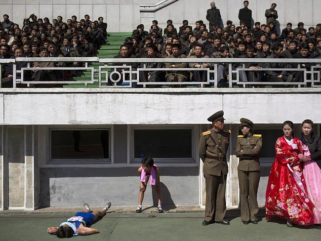 Taking a break ... runners rest inside Kim Il Sung Stadium in Pyongyang during last year’s marathon.