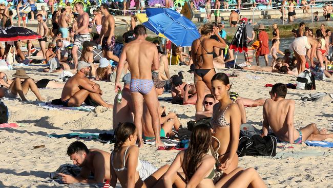 Sunbathers were clearly not practising social distancing, as they squeezed together on the sand. Picture: AAP.