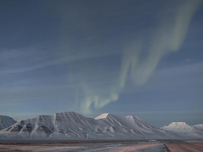 Twilight Aurora ... On the evening of the total solar eclipse in 20 March 2015, the people of Spitsbergen were treated to a second natural lightshow in the form of the Aurora Borealis. At the time the photograph was taken the Sun was shining 9 degrees below the horizon, meaning it was evening nautical twilight on the shore of Greenland Sea. The Adventtoppen Mountain, standing at 2,579ft tall, towers over the orange-hued expanse in the foreground, as the Northern Lights gambol across the night sky. Picture: György Soponyai, Insight Astronomy Photographer of the Year 2016 Aurorae Winner