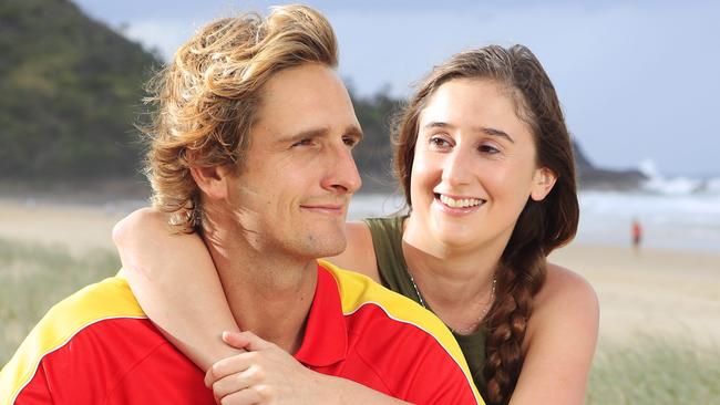 24 year old Stevi Everson with her Hero James Cervi 26, who she says 'definitely saved her life' as she came off her Dads Jetski in massive swells at Noosa's outer points on Sunday. Off Duty Noosa Lifeguard James swam to her aid, kept her afloat for over 20 minutes while 2 metre waves crashed on top of them relentlessly and swam her to a protected area where she was treated by paramedics and taken to hospital. Photo Lachie Millard