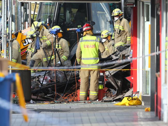 The bodies are removed from the site. Picture: Ross Schultz