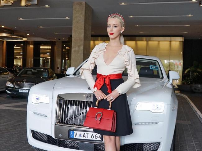 Posing with a luxury limo.