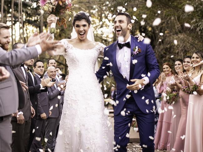 Confetti throwing on happy newlywed couple. ISTOCK Wedding generic