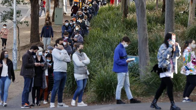 People wait in the long line to get their Covid-19 jab at the NSW Health Vaccination Centre in Sydney Olympic Park. Picture: Jonathan Ng