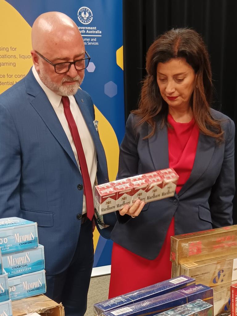 Consumer Affairs Commissioner Martyn Campbell and Consumer and Business Affairs Minister Andrea Michaels inspecting some of the illegal tobacco items seized during a raise in the northeastern suburbs. Picture: Elizabeth Henson