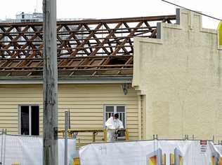 Workers remove the roof from the old firemans hall in Limestone Street in preparation for its demolition to extend the McDonald's carpark. Picture: Rob Williams