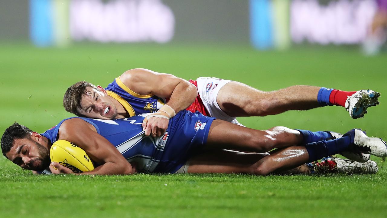 Tarryn Thomas overpowered by Jarryd Lyons at Blundstone Arena. Picture: AFL Photos/via Getty Images)