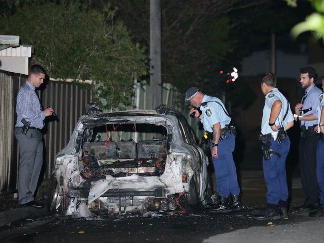 A burnt-out white Mercedes, believed to be connected with the Auburn shooting, was found a short time late in Punchbowl. Picture: Bill Hearne