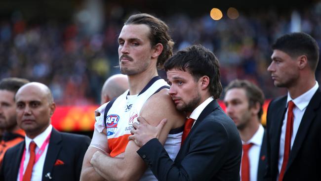 Dylan Buckley consoles GWS skipper Phil Davis after this year’s grand final. Picture. Phil Hillyard