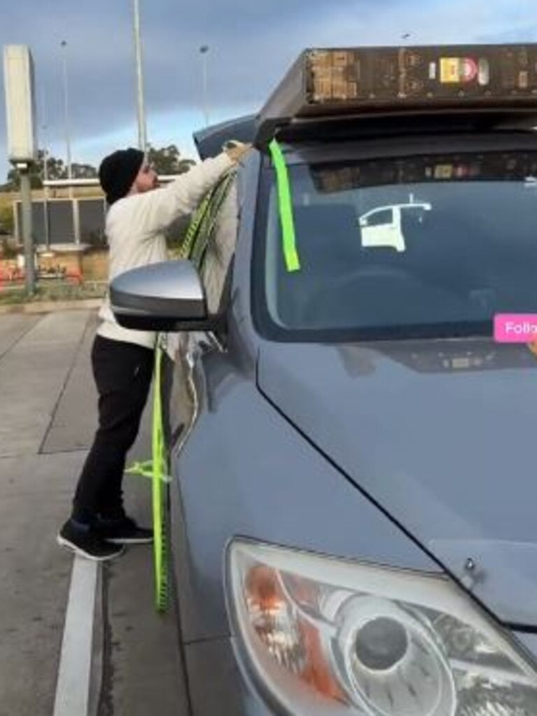 The couple had to secure the television to the top of their car. Picture: TikTok/angeli.yuson