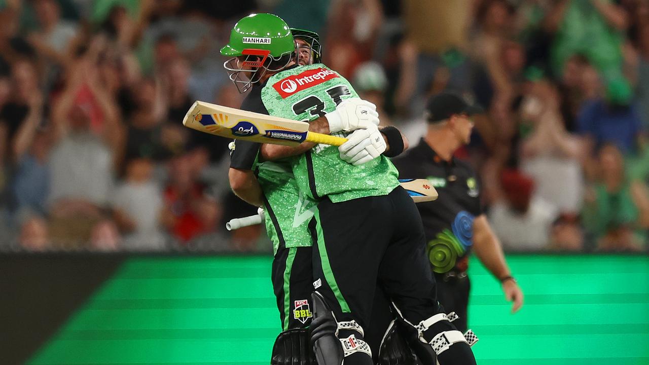 Hilton Cartwright (front) is embraced by Glenn Maxwell after he hit the winning runs for the Melbourne Stars against the Melbourne Renegades on Saturday night. Picture: Mike Owen / Getty Images